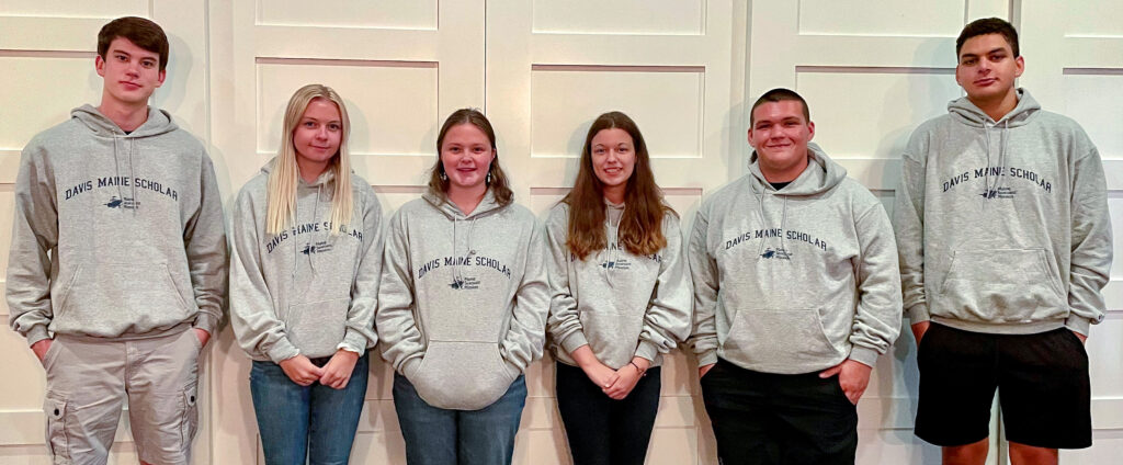 6 students wearing matching sweatshirts