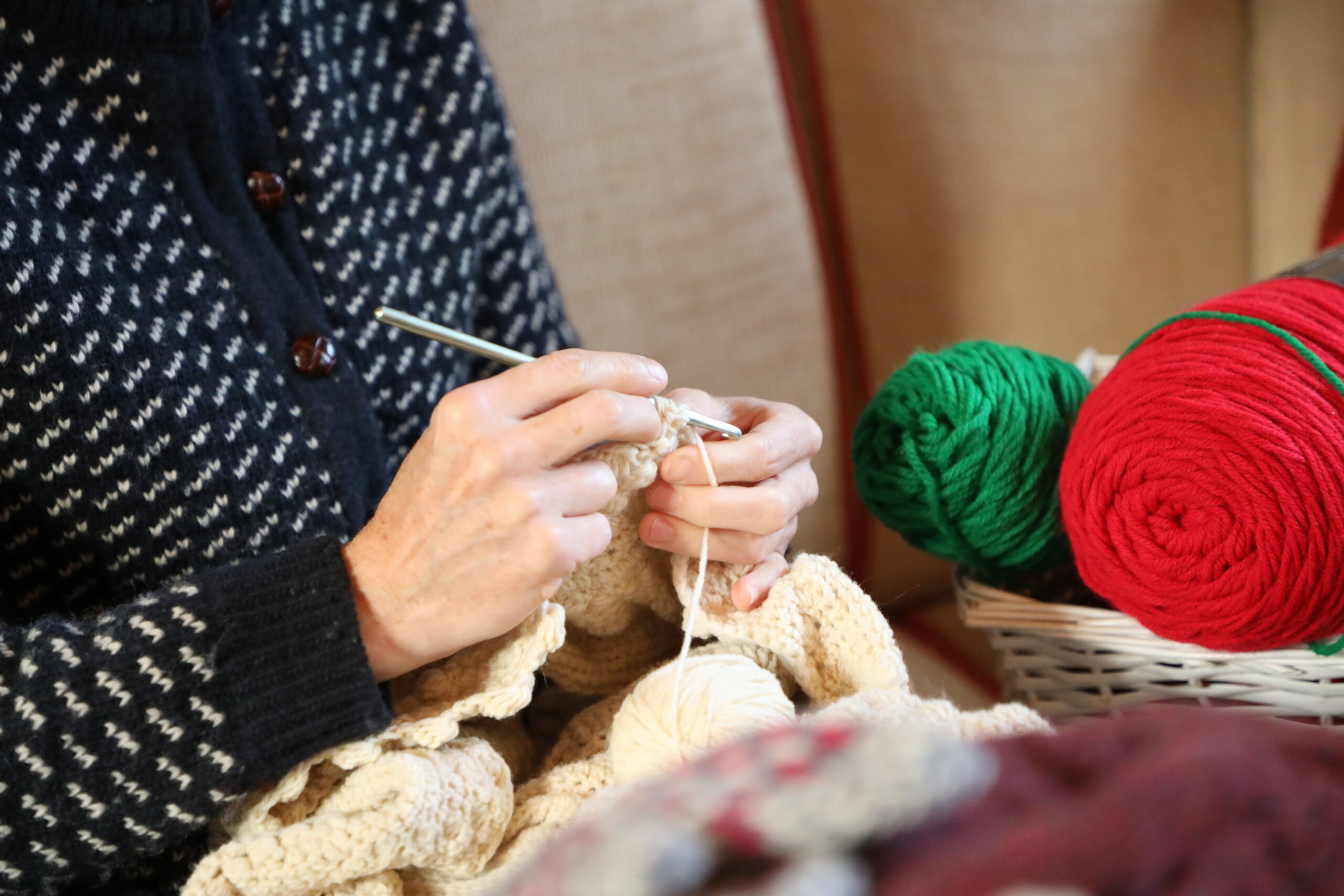 A color photo of a person crocheting