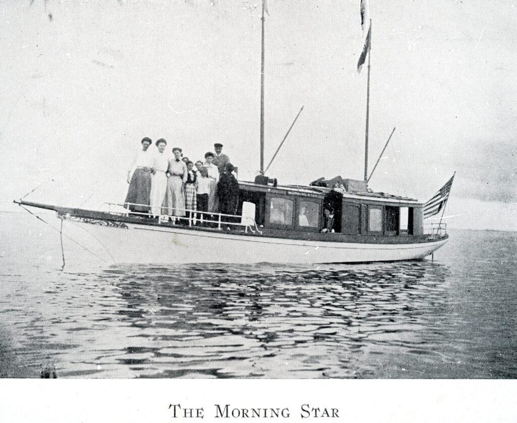 A black and white photo of a boat with passengers standing on the hull. Labeled Morning Star