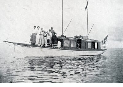 A black and white photo of a boat with passengers standing on the hull. Labeled Morning Star