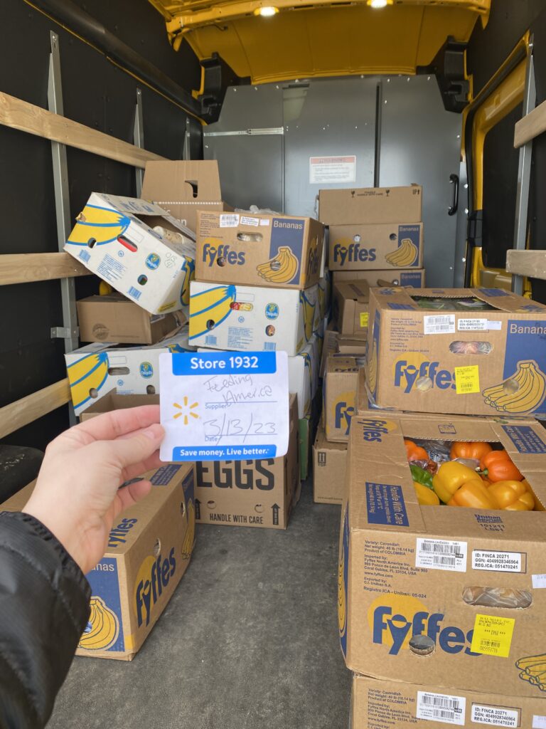 A color picture of a truck filled with food donations