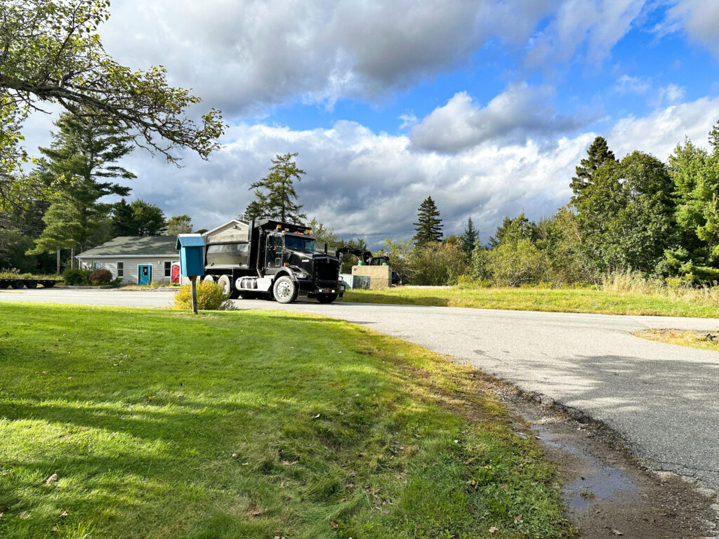 A color photo of a dump truck on the Downeast Campus