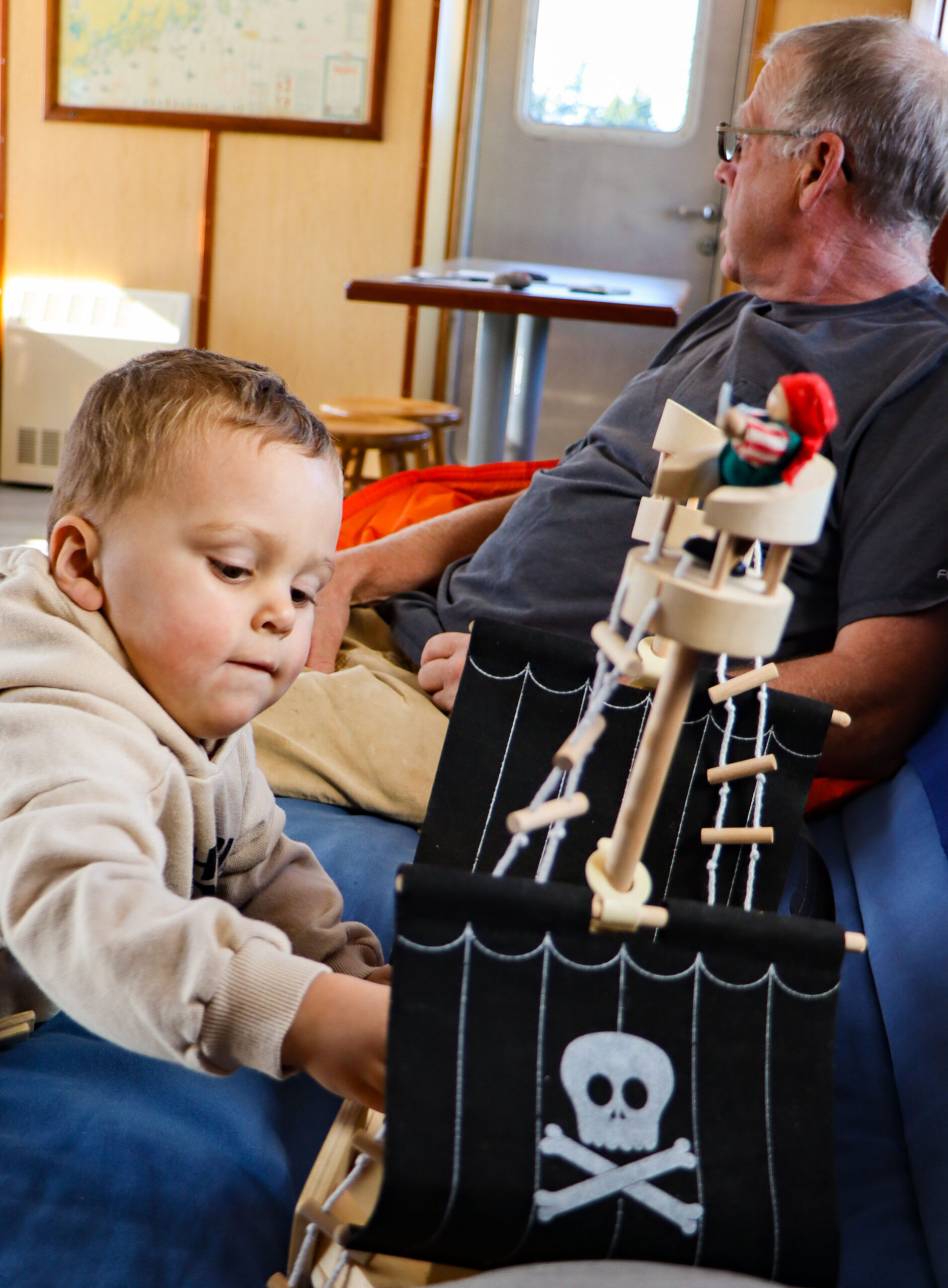 A young boy plays with a pirate ship 