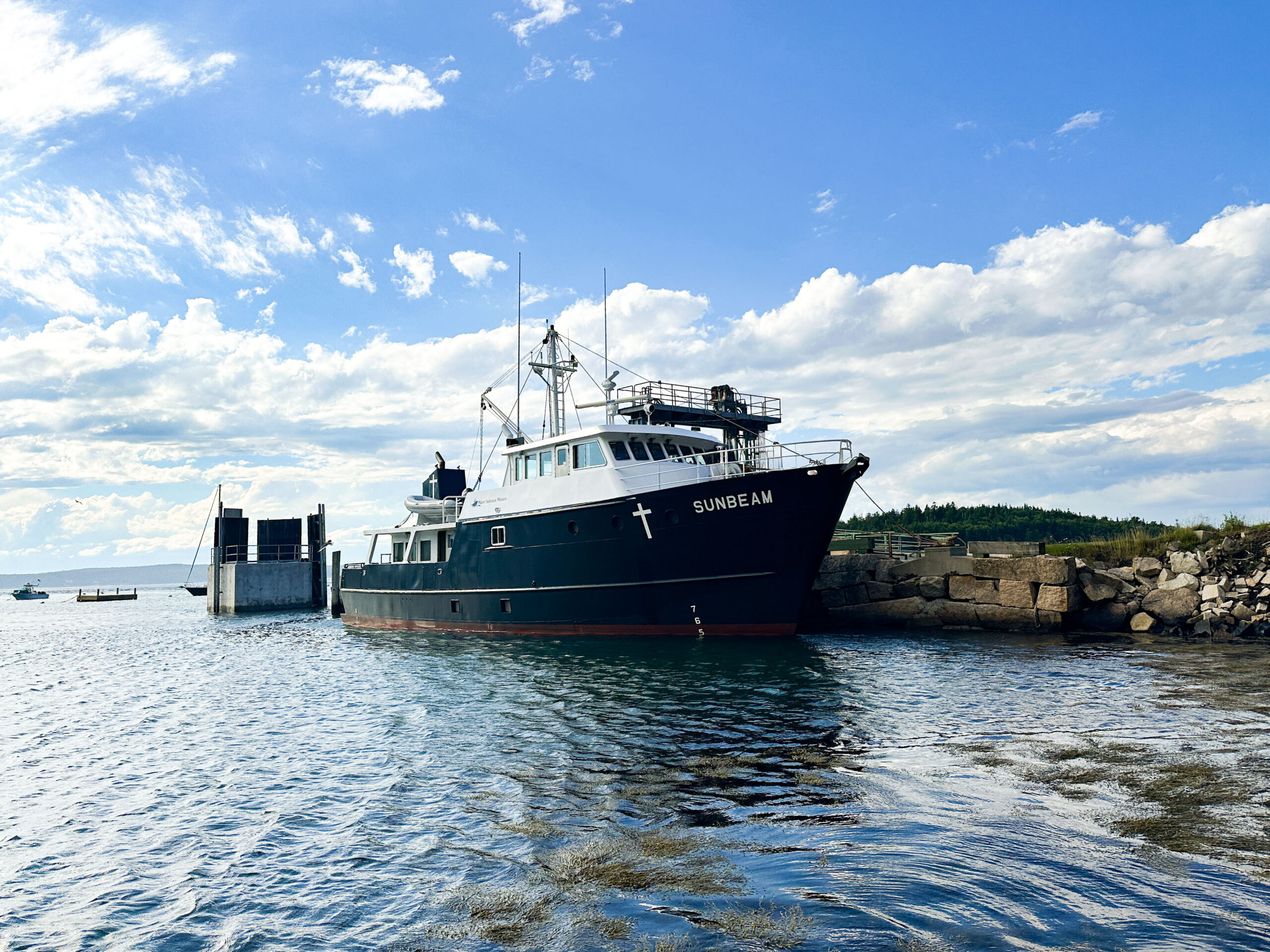 A picture of the Sunbeam boat docked on Frenchboro. The boat is seen from far away.