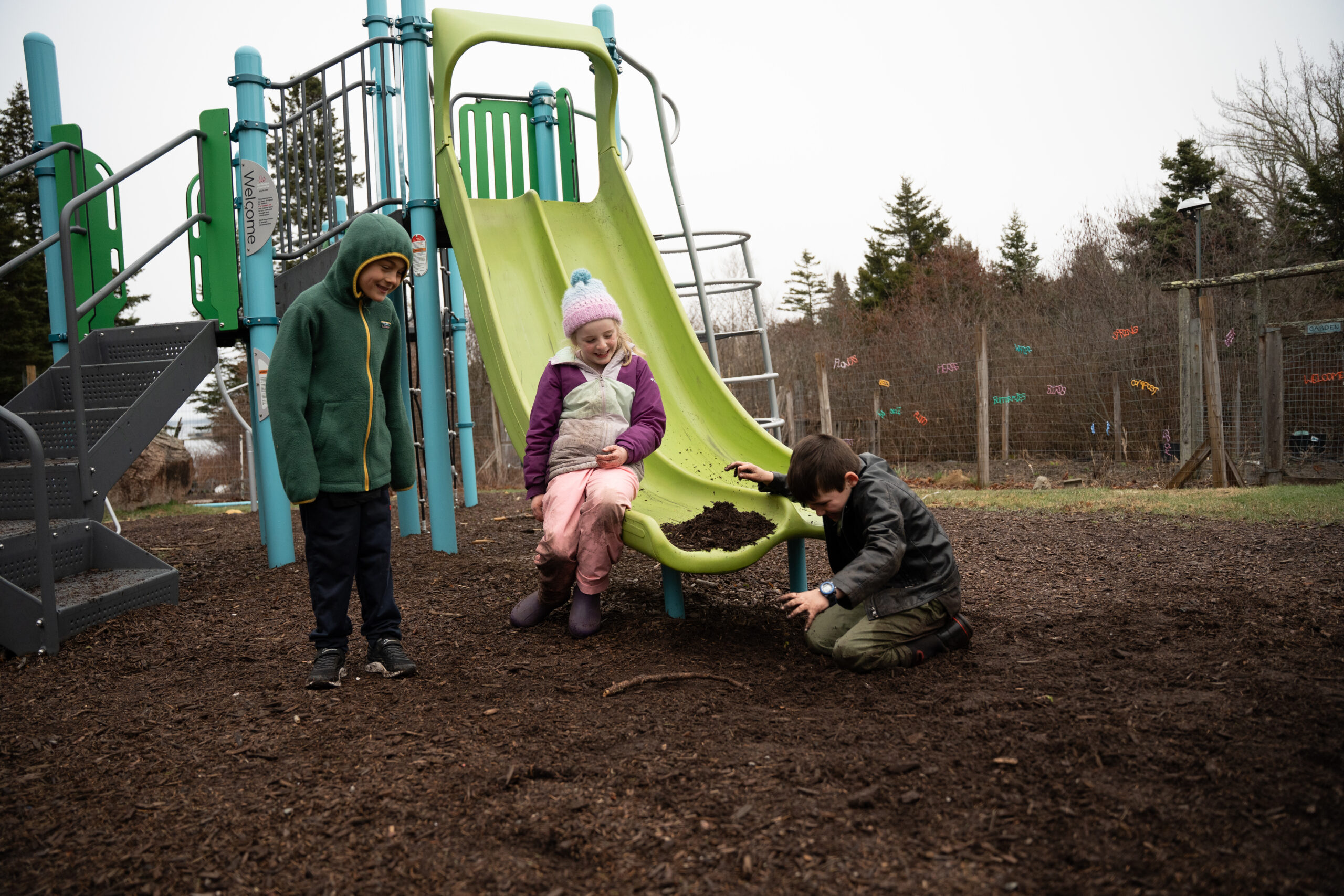 Children playing on slide on island