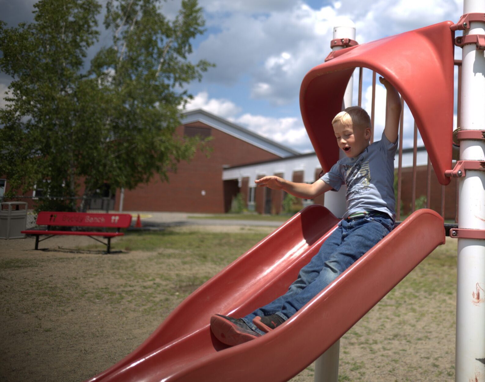 Students play on slide at EdGE