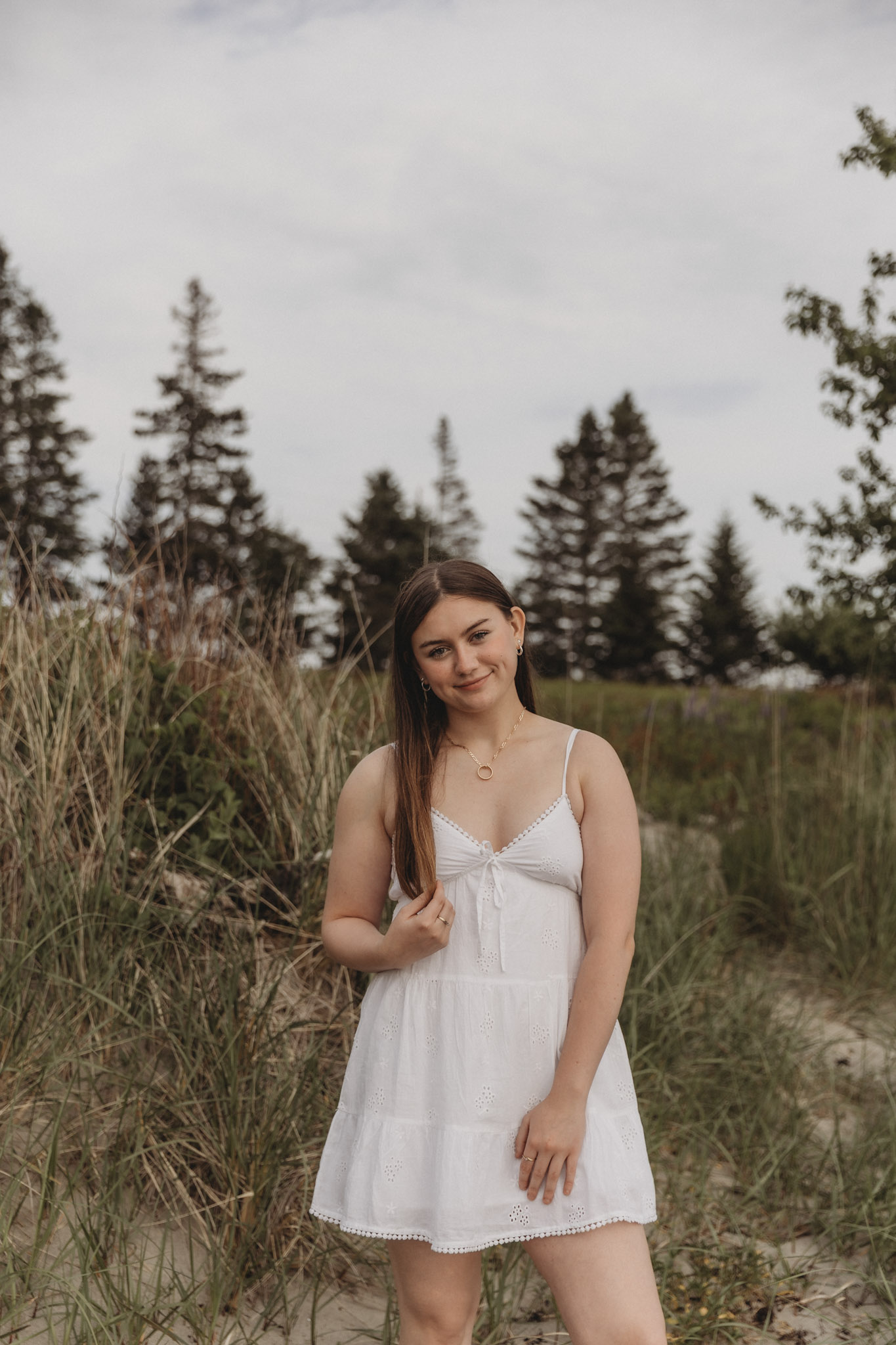 girl standing in front of beach and trees