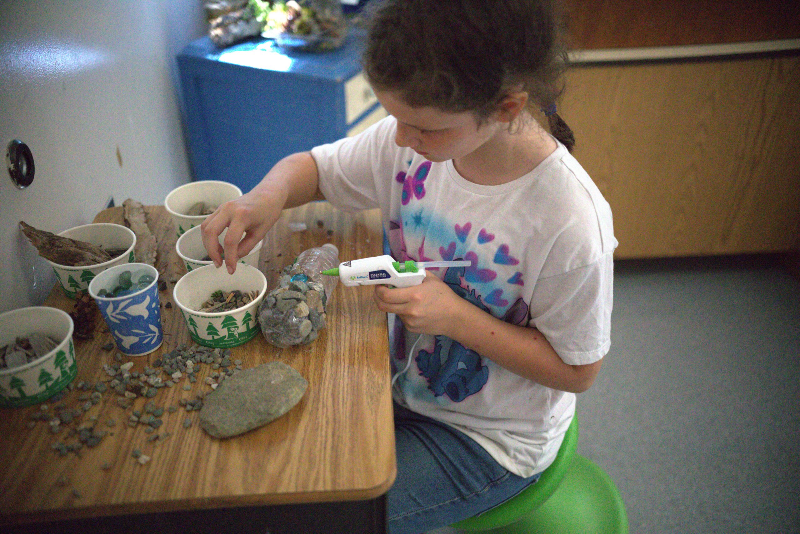 Student building fairy house