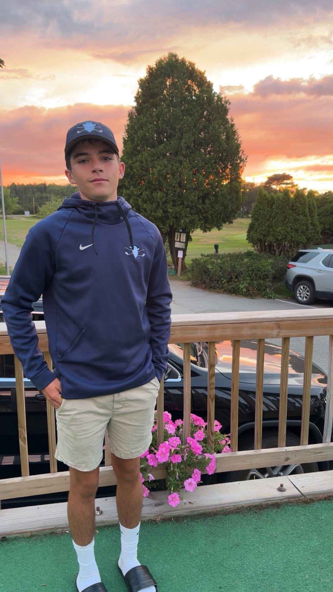 boy standing in front of sunset
